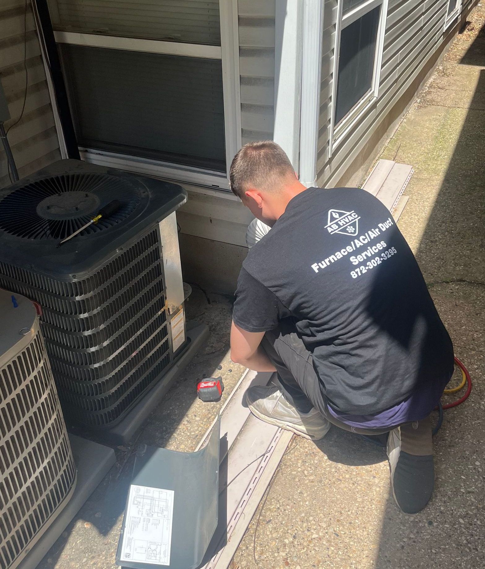 AB tech working on an AC unit